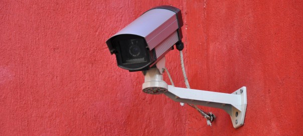 security camera against a red background