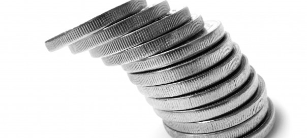 a pile of silver coins tilting to the left